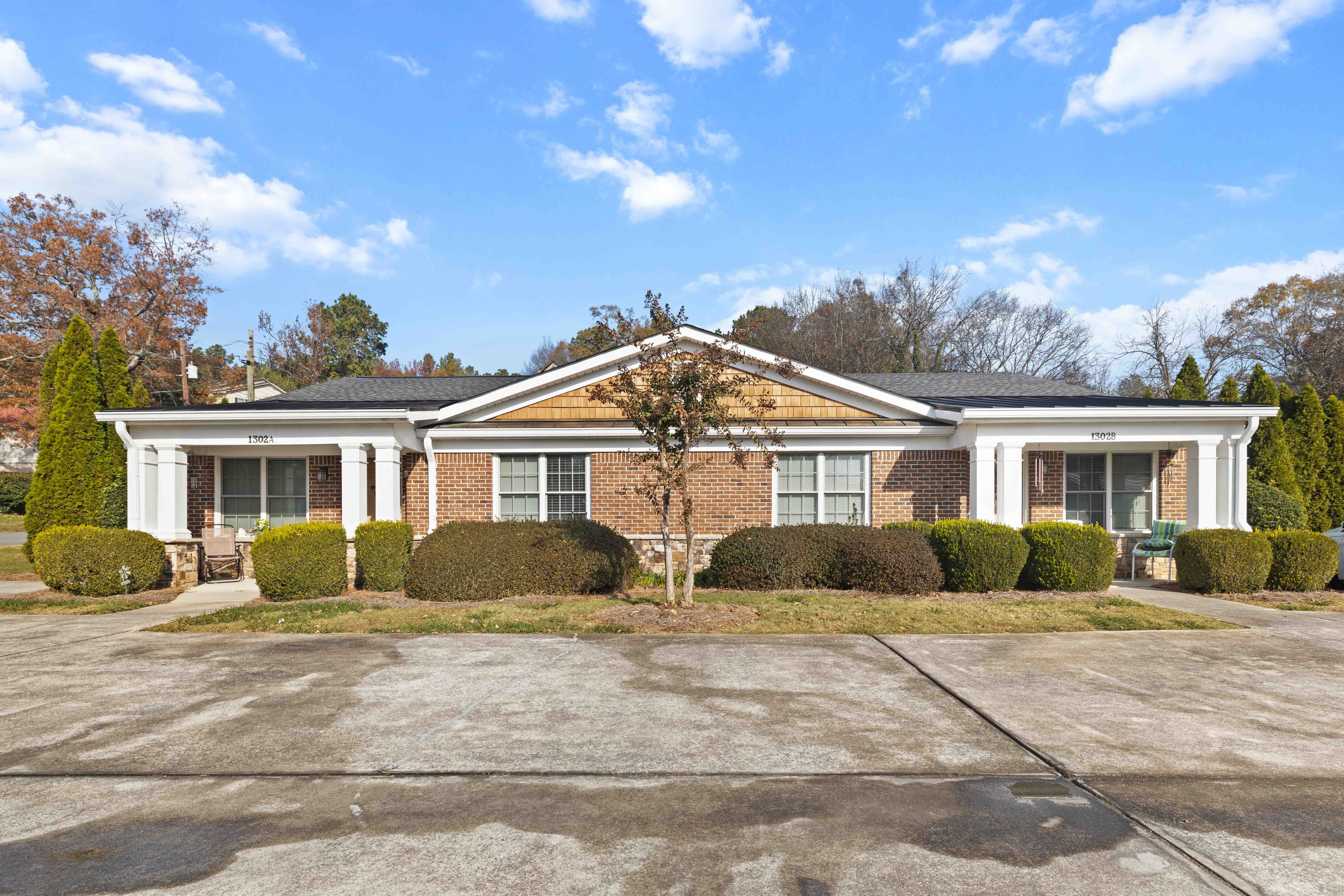 A house with a brick facade and a large front yard.